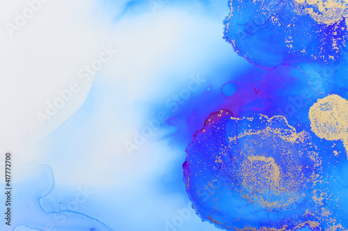 art photography of abstract fluid art painting with alcohol ink  blue and gold colors