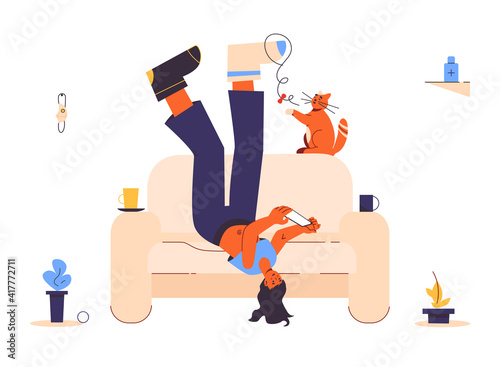 Lazy depressive woman wearing  different mismatched colored socks. Lonelines. Lying upside down on the couch. Playing with smartphone and cat. Boring exhausting day in mess. Apathy concept. Isolated. 