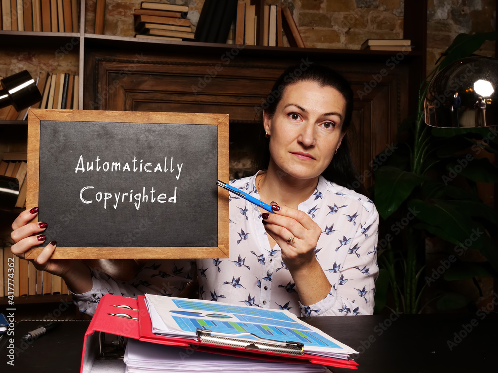 Fototapeta premium Business concept meaning Automatically Copyrighted with sign on chalkboard.