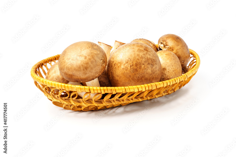 Champignons in a wicker plate isolated on white Champignons in a wicker plate isolated on white