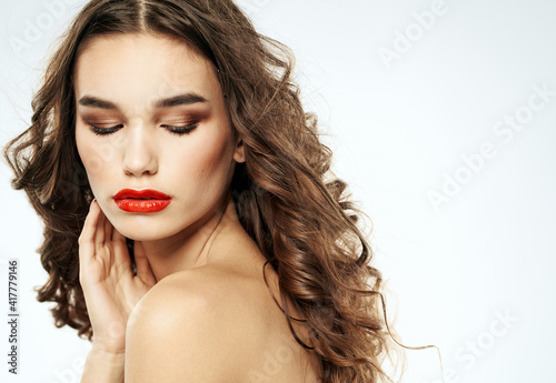 Charming lady with closed eyes eyeshadows and bright makeup red lips