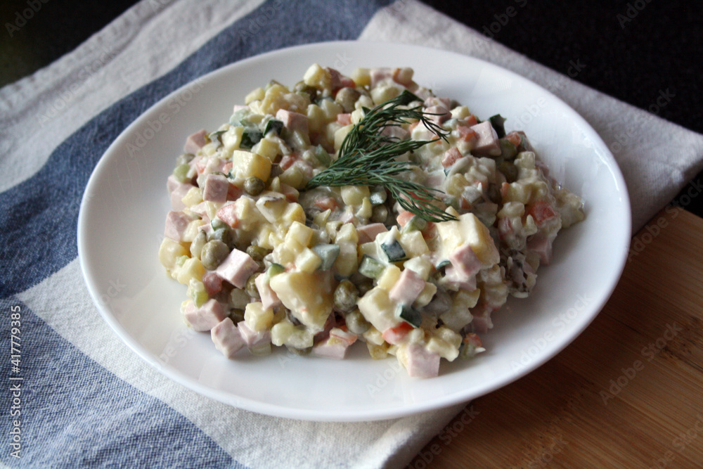 Salad of potatoes, sausage, peas, carrots and cucumbers. Olivier. Salad of potatoes, sausage, peas, carrots and cucumbers. Olivier.