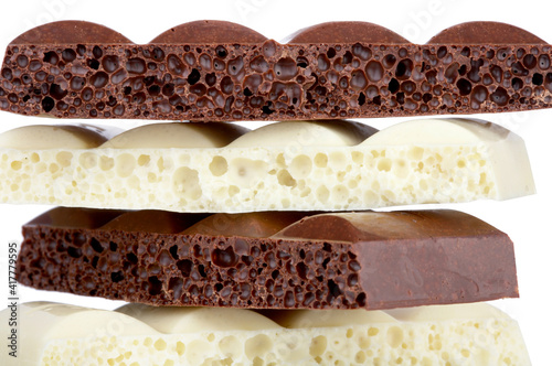 Stack of brown and white porous chocolate isolated on the white background