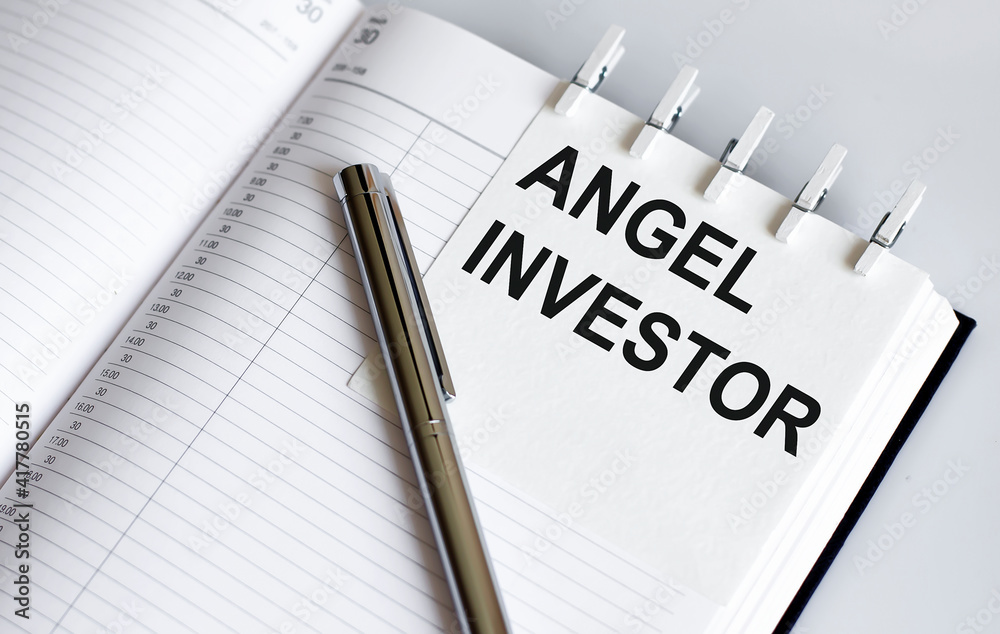 text Angel Investor on the short note texture background with pen text Angel Investor on the short note texture background with pen