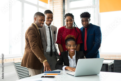team of young african people in the office at the table with a laptop 