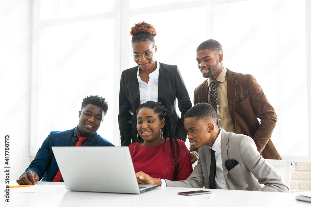 team of young african people in the office at the table with a laptop 