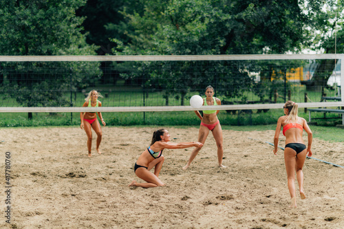 Young women playing beach volleyball