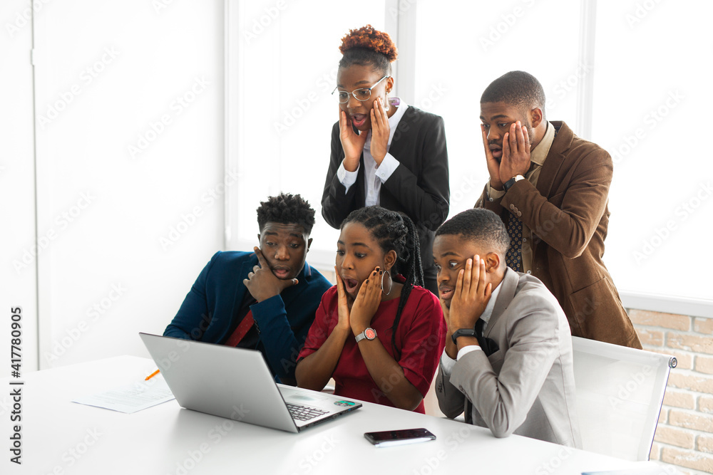 team of young african people in office with surprised faces team of young african people in office with surprised faces