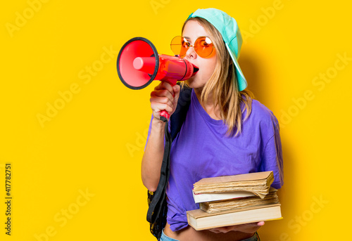 girl in purple clothes with pink megaphone and books