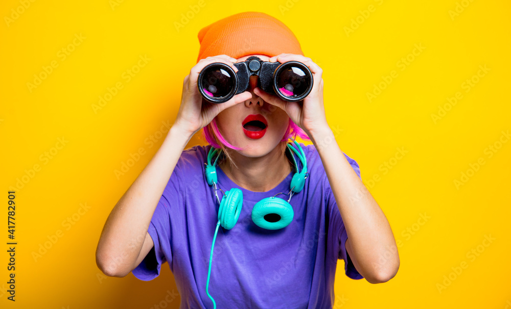 Young style girl in purple clothes with binoculars Young style girl in purple clothes with binoculars