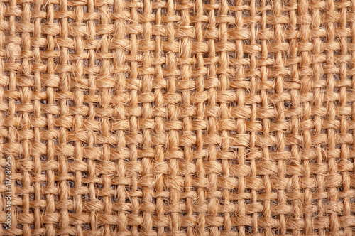 Close-up of natural burlap hessian sacking. Background texture using burlap material.