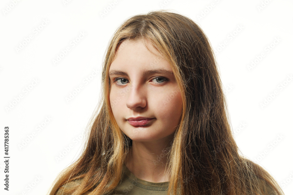 Portrait of young teenager on a white background. Classic style, face three quarter turn position. Brown color long rich hair, grey eyes., looking at the viewer Portrait of young teenager on a white background. Classic style, face three quarter turn position. Brown color long rich hair, grey eyes., looking at the viewer
