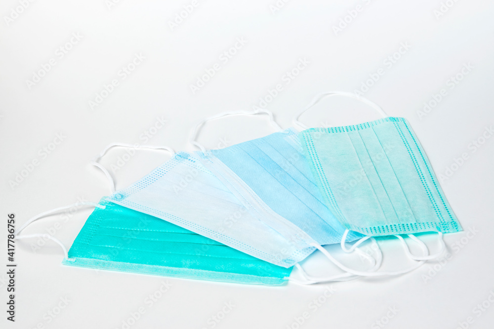 Surgical mask on white background, close-up.