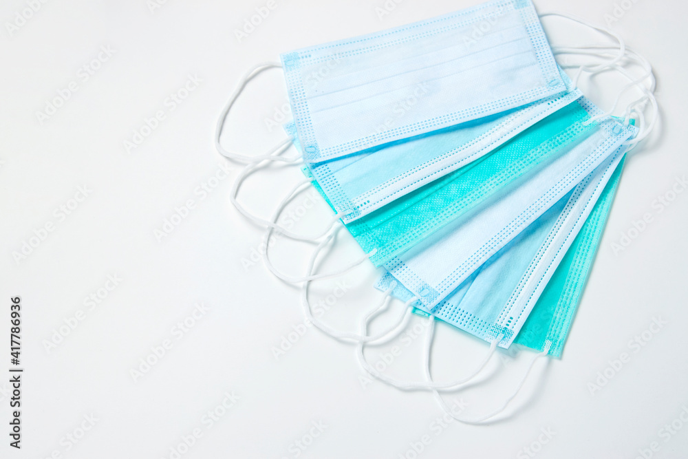 Surgical mask on white background, close-up. Surgical mask on white background, close-up.