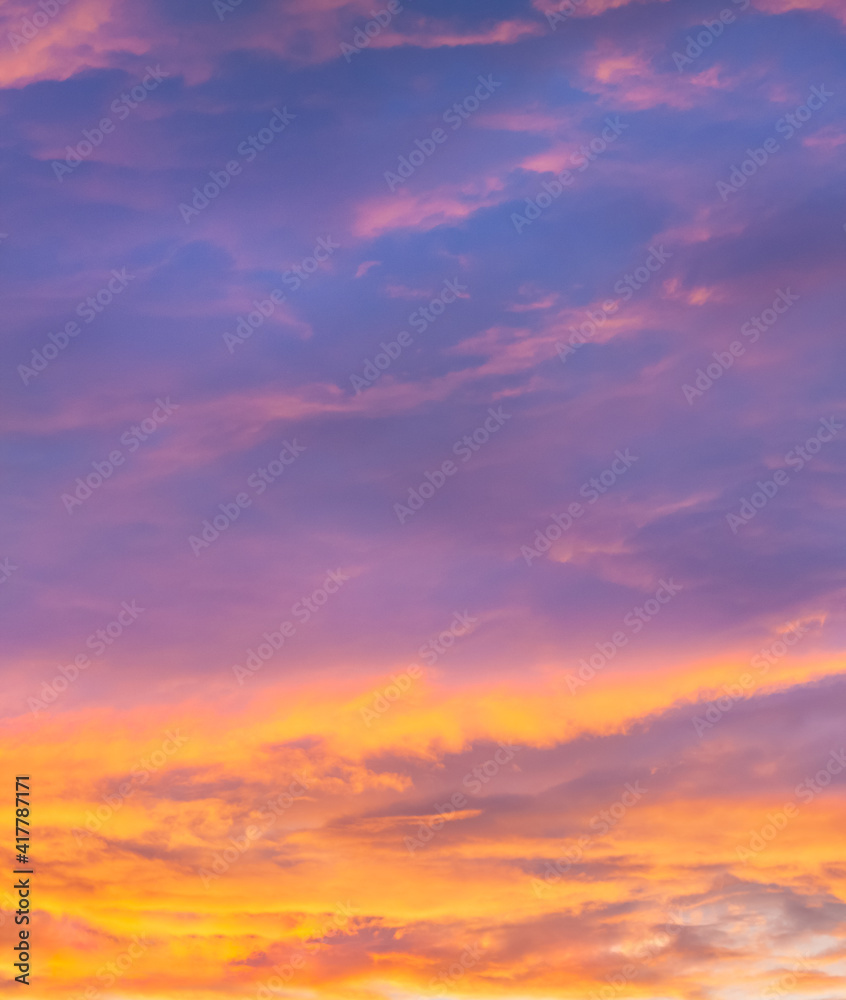 Violet and orange sunset sky with clouds