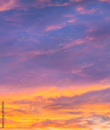 Violet and orange sunset sky with clouds