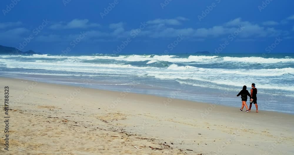 Campeche beach in Brazil. Panoramic shot of the wide sandy beach of Campeche during stormy weather and heavy waves Campeche beach in Brazil. Panoramic shot of the wide sandy beach of Campeche during stormy weather and heavy waves