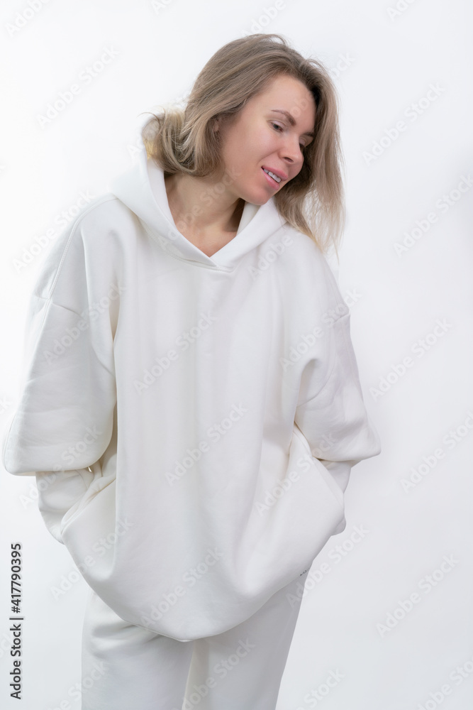 smiling girl in white tracksuit posing on white background smiling girl in white tracksuit posing on white background