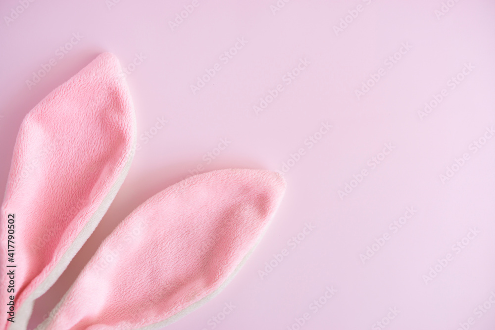 Easter greeting card  .Pink  eggs and bunny ears  on pink  pastel background with  copy spase  . Easter minimal concept. Flat lay. advertising concept .