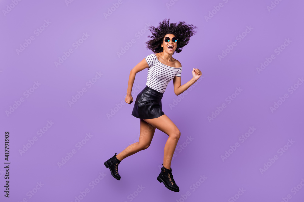 Full body profile portrait of carefree energetic dark skin person rush speed open mouth isolated on purple color background