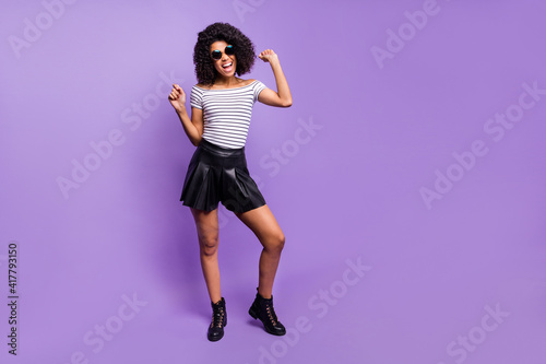 Full body photo of excited funny dark skin person raise hands open mouth smile isolated on violet color background