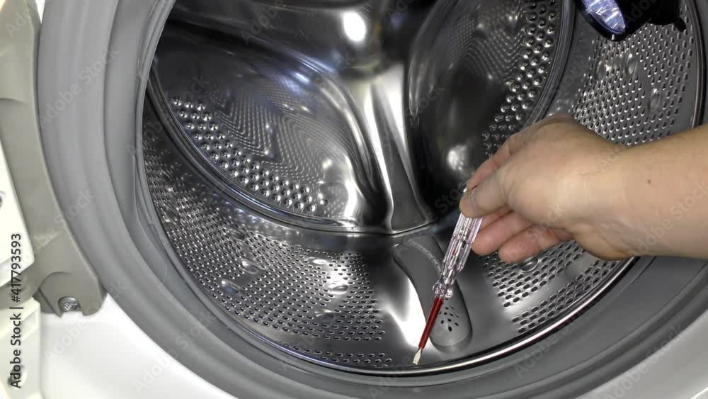 There is an electrical leak in the washing machine. The indicator shows the presence of voltage.