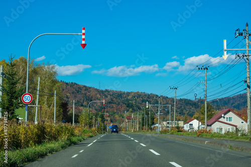 Rural road at autumn in Furano Township, Hokkaido, Japan.