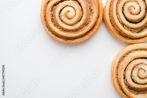 cinnamon buns on a white plate, a snail bun on a white plate