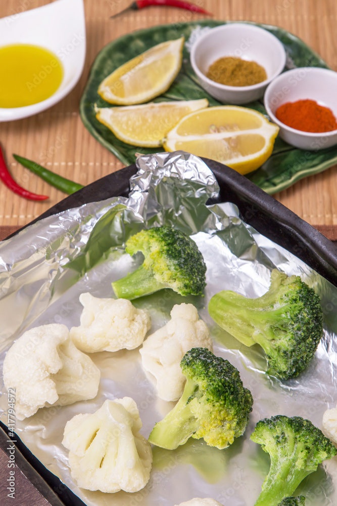 Frozen vegetables broccoli and cauliflower for cooking in foil in oven. Vegan vegetarian healthy diet food Frozen vegetables broccoli and cauliflower for cooking in foil in oven. Vegan vegetarian healthy diet food
