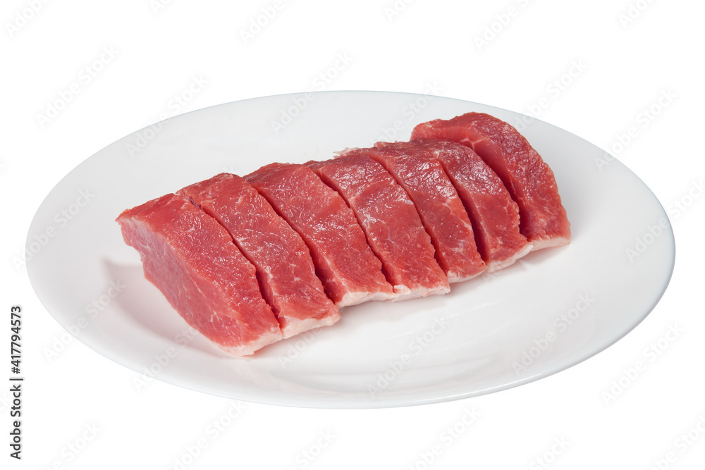 Pieces of raw meat on a white plate Pieces of raw meat on a white plate