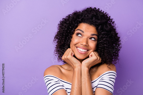 Portrait of adorable cheerful dark skin girl hands on cheeks look empty space isolated on purple color background