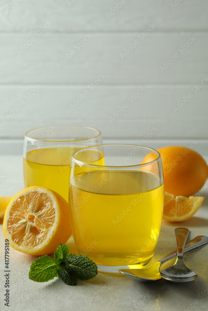 Concept of dessert with lemon jelly on white textured table Concept of dessert with lemon jelly on white textured table