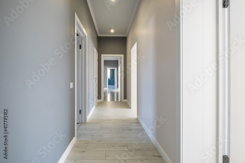 long white empty corridor in interior of entrance hall of modern apartments  office or clinic
