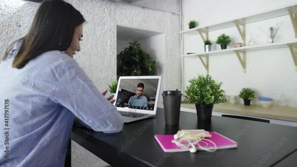 Male student learning using computer webcam chat makes notes. Home quarantine, social distancing, self isolation. Male student learning using computer webcam chat makes notes. Home quarantine, social distancing, self isolation.