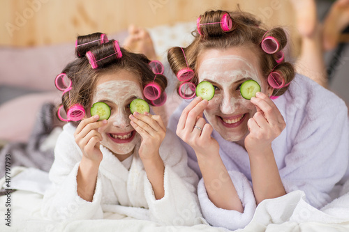 mom and daughter make face masks with cucumber