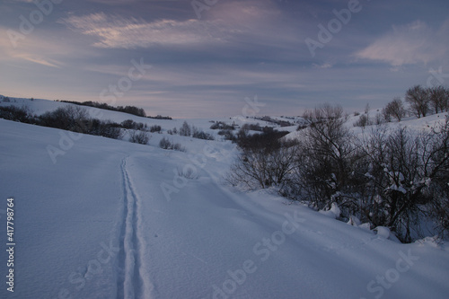 Dawn evening winter landscape with ski track