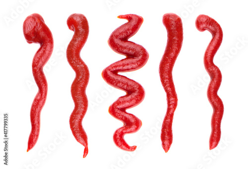 Ketchup splashes, group of objects. Arrangement of red ketchup or tomato sauce, isolated white background, top view.