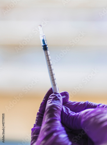 Detail of hands with purple gloves