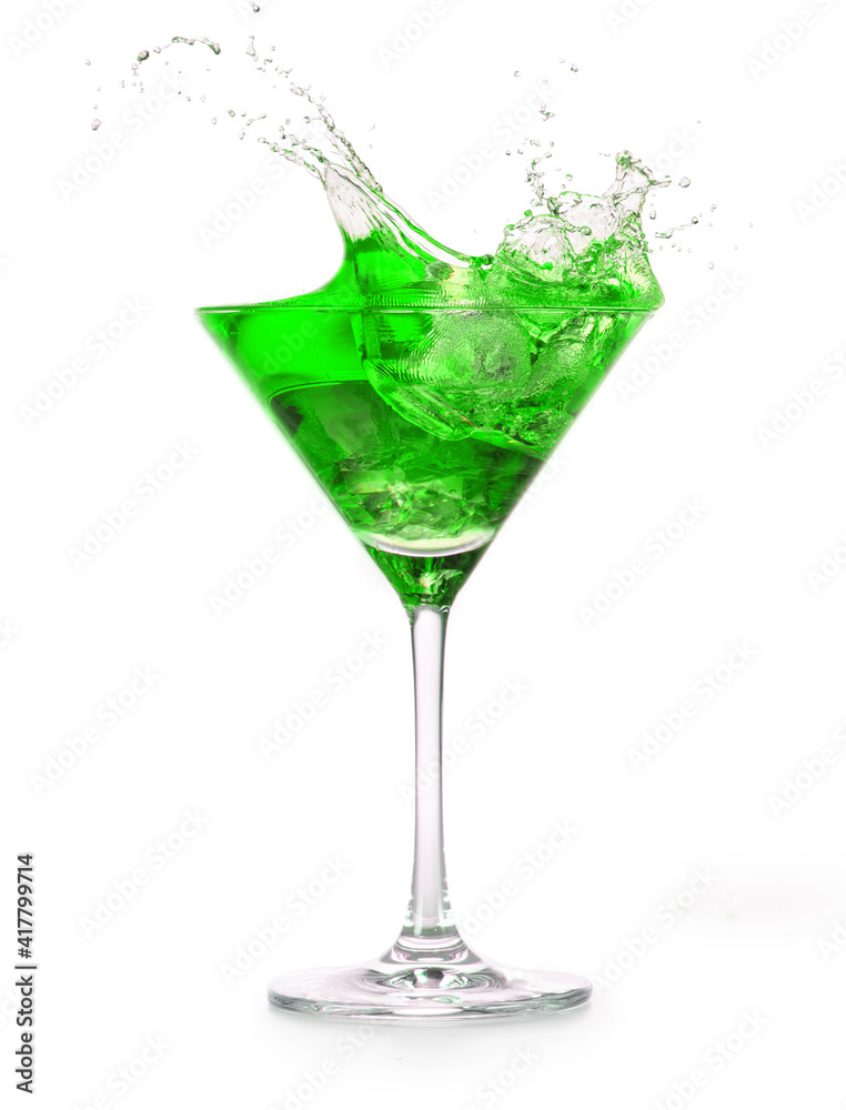 green cocktail splashing into a martini glass isolated on white background green cocktail splashing into a martini glass isolated on white background