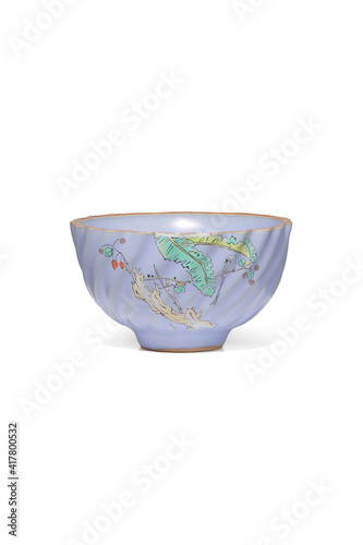 Wallpaper Mural Subject shot of violet ceramic bowl with glazed surface, crazing and floral Japanese design. Simple wavy teabowl is isolated on white surface. Torontodigital.ca