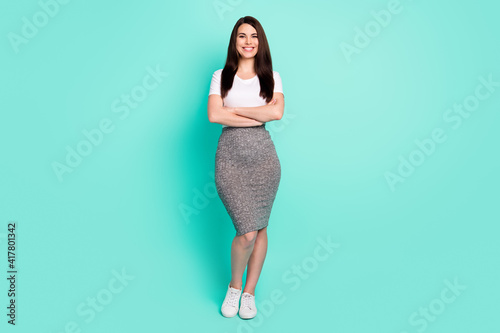 Full size photo of young cheerful girl happy positive smile crossed hands wear casual outfit isolated over teal color background