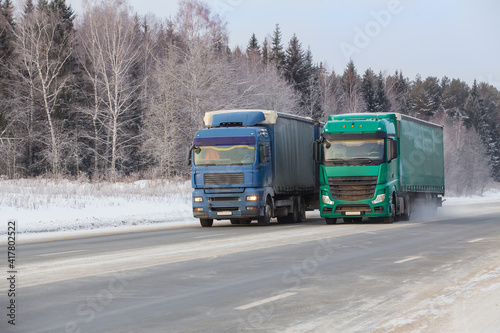 Trucks move in winter on a snowy road