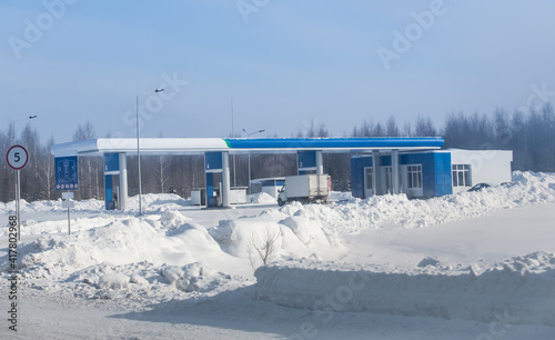 Gas station in winter on highway photo