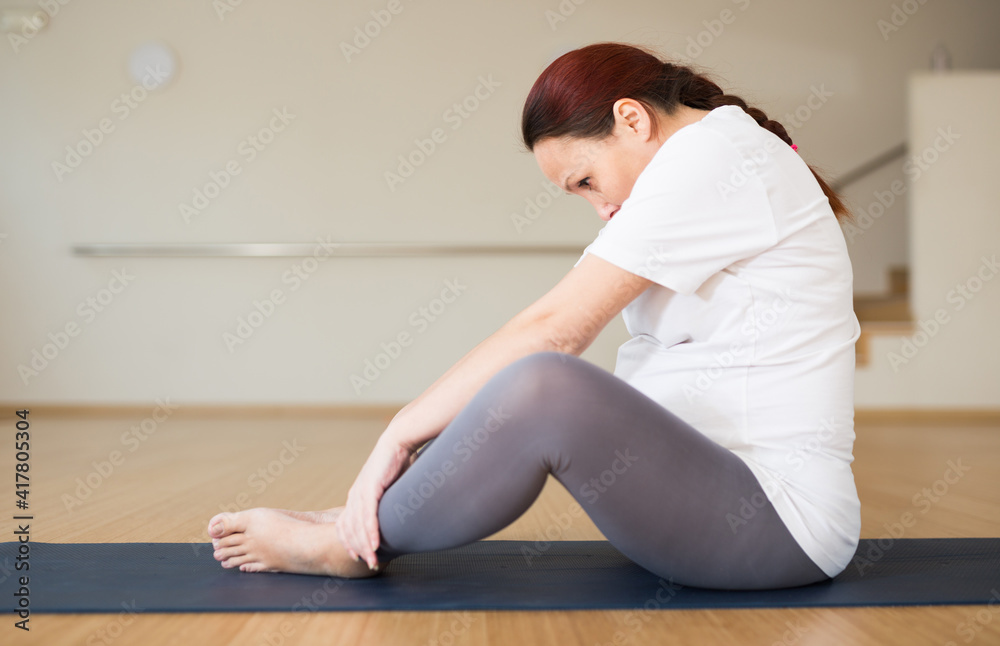 Pregnant woman is engaged in yoga. Butterfly Pose or Baddha Konasana