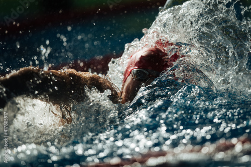 Swimming crawl sportsman with splashes