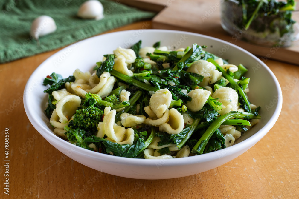 Typical dish of Italian cuisine, orecchiette with turnip greens. Vegan food, healthy dish, fast lunch. Orecchiette con cime di rapa. Typical dish of Italian cuisine, orecchiette with turnip greens. Vegan food, healthy dish, fast lunch. Orecchiette con cime di rapa.