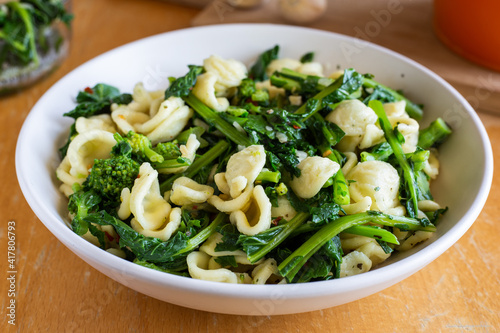 Typical dish of Italian cuisine, orecchiette with turnip greens. Vegan food, healthy dish, fast lunch. Orecchiette con cime di rapa.