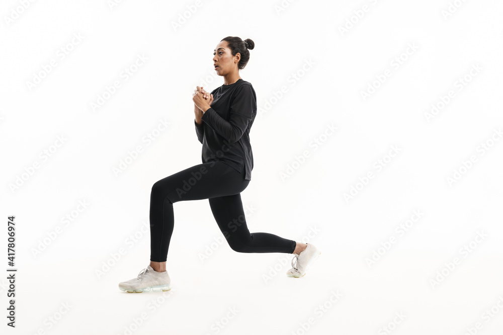 Focused african american woman doing exercise while working out