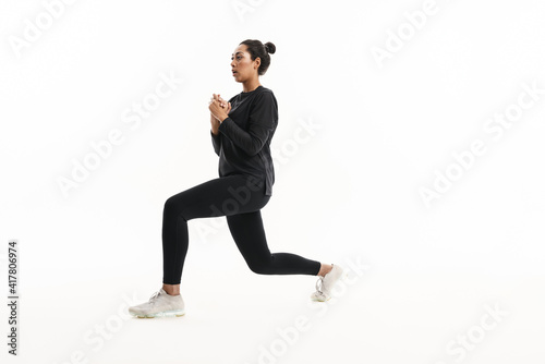 Focused african american woman doing exercise while working out