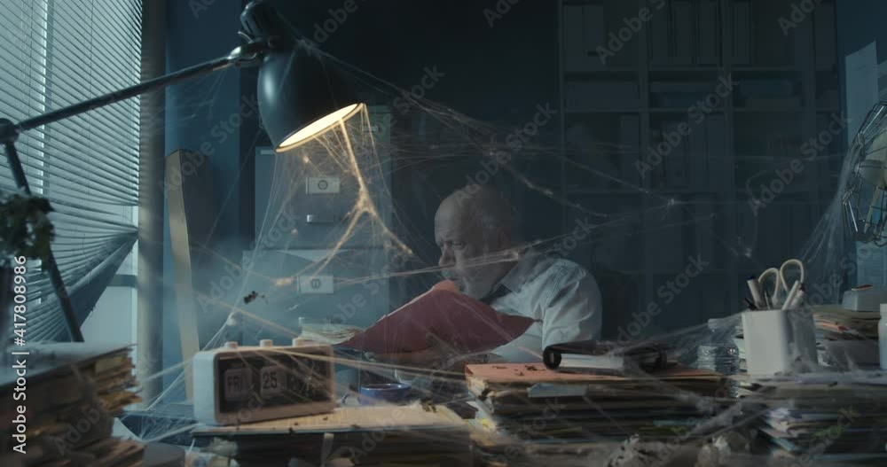 Businessman searching for files in his abandoned office